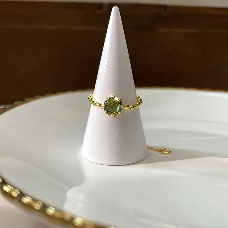 Women's fashionable ring with a chain of round beads