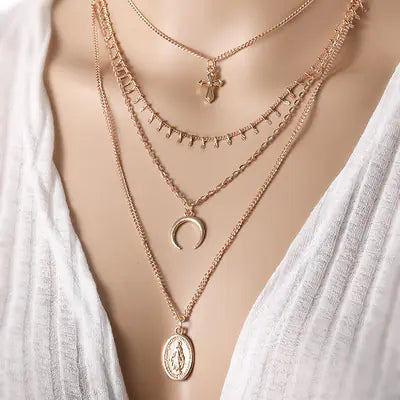 Layered necklace with a bird and feather motif.