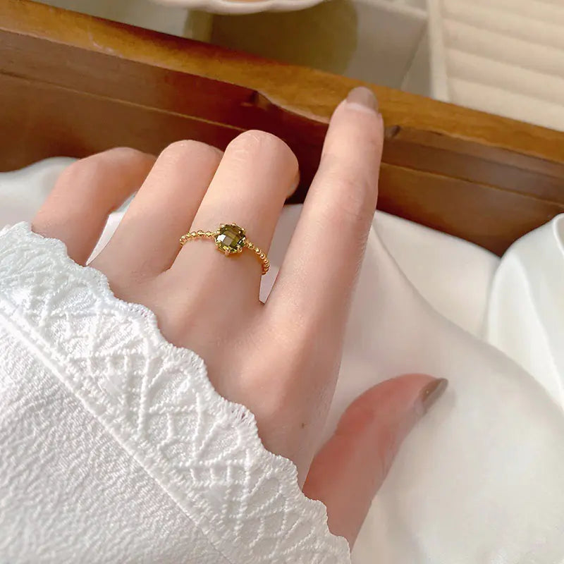 Women's fashionable ring with a chain of round beads